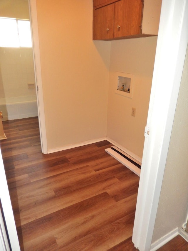 laundry area featuring dark wood-style floors, cabinet space, baseboards, and washer hookup