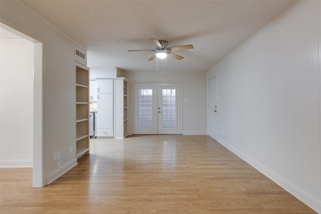 foyer with visible vents, a textured ceiling, french doors, light wood-style floors, and ceiling fan