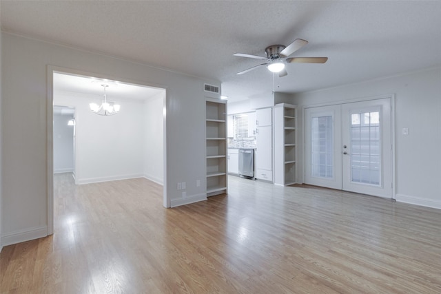 unfurnished living room with visible vents, french doors, a textured ceiling, crown molding, and light wood-type flooring