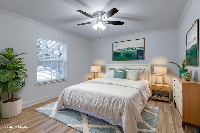 bedroom with ceiling fan, light wood-type flooring, baseboards, and ornamental molding