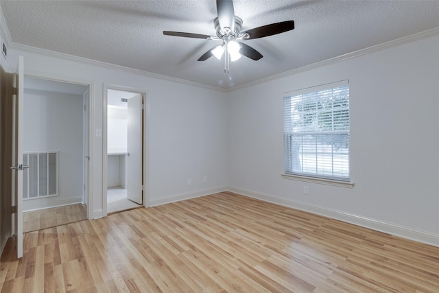 unfurnished bedroom with visible vents, a textured ceiling, light wood-style floors, and ornamental molding