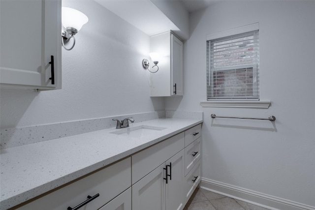 bathroom featuring vanity, baseboards, and tile patterned flooring