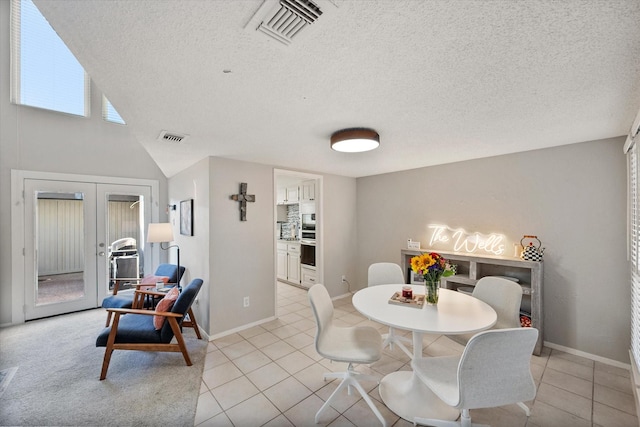 dining space featuring light tile patterned floors, french doors, and visible vents