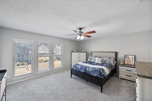 bedroom with baseboards, ceiling fan, and carpet flooring