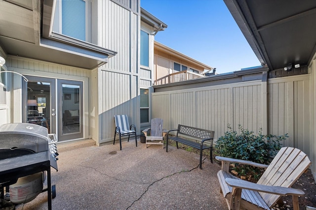 view of patio featuring area for grilling and fence