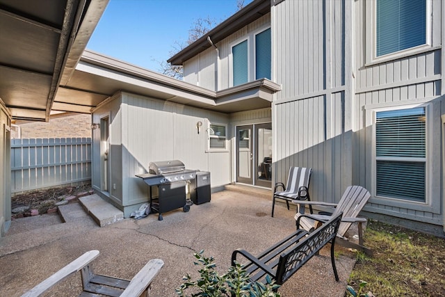 view of patio / terrace with area for grilling and fence