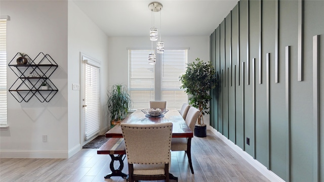 dining room with baseboards and wood finished floors