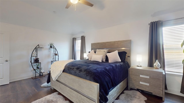 bedroom featuring dark wood finished floors, baseboards, and ceiling fan