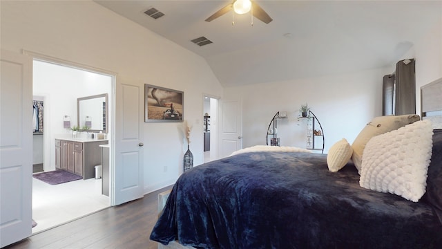 bedroom with lofted ceiling, dark wood-style floors, visible vents, and ensuite bathroom