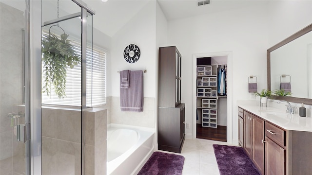 bathroom with vanity, tile patterned floors, a bath, and a shower stall