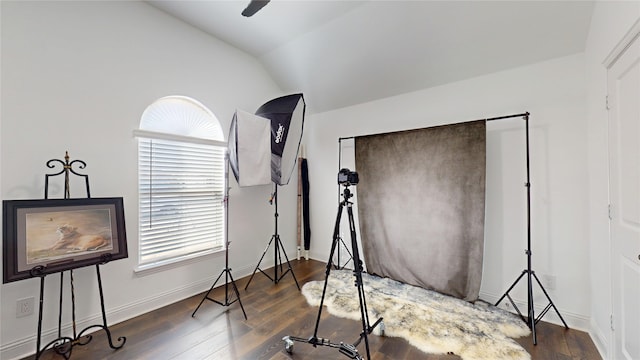 interior space featuring baseboards, hardwood / wood-style flooring, ceiling fan, and vaulted ceiling