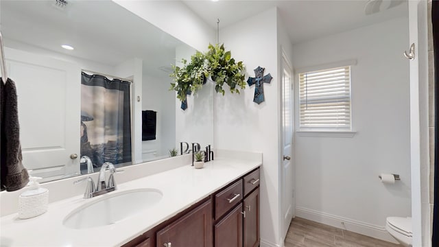 full bathroom featuring visible vents, toilet, wood finished floors, baseboards, and vanity