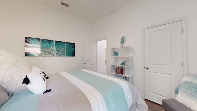 bedroom featuring visible vents and wood finished floors