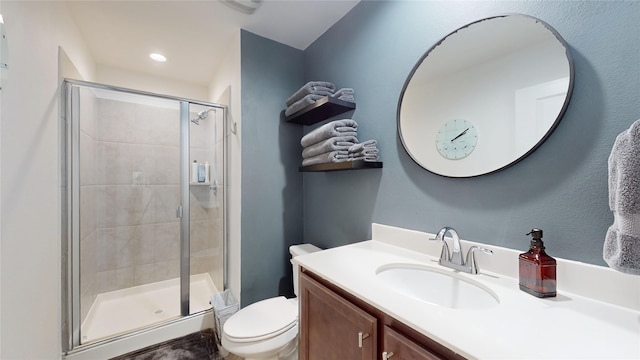 full bathroom featuring recessed lighting, a shower stall, toilet, and vanity