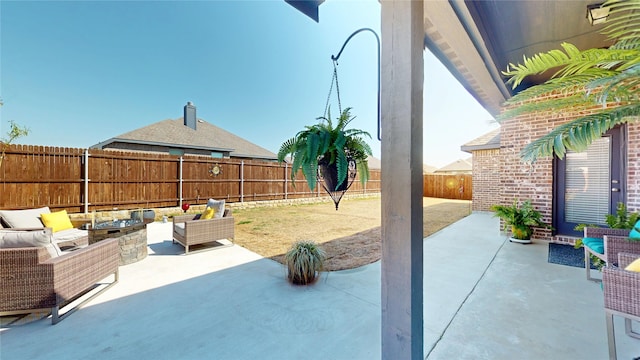 view of patio with an outdoor living space with a fire pit and a fenced backyard