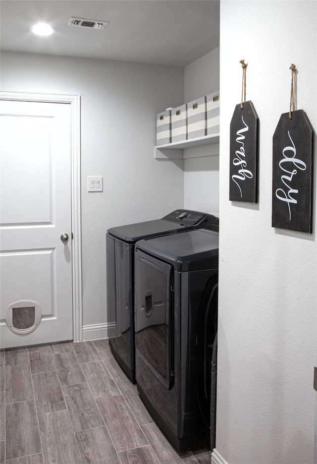 1525 Wagon Wheel Way, Krum, TX 76249 - washroom with washing machine and clothes dryer, wood finished floors, and baseboards