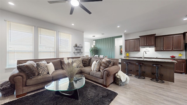 living room featuring recessed lighting, a healthy amount of sunlight, and light wood finished floors