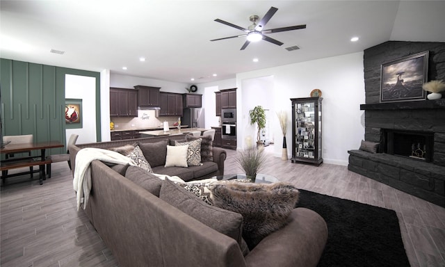 1525 Wagon Wheel Way, Krum, TX 76249 - living room with a fireplace, ceiling fan, light wood finished floors, recessed lighting, and baseboards