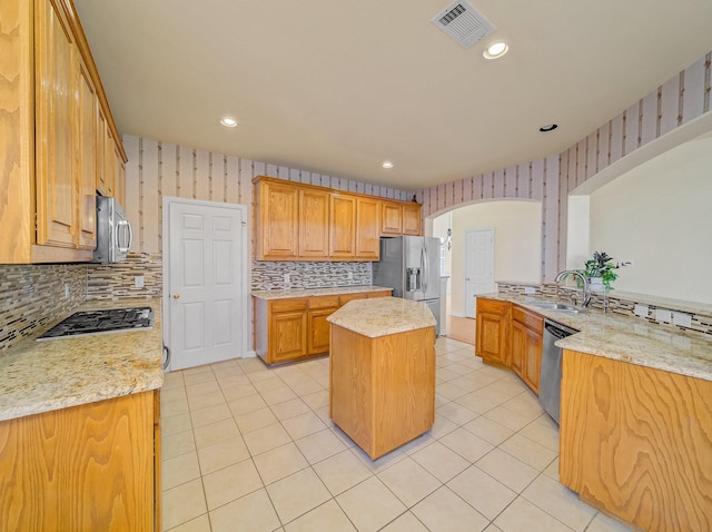 kitchen featuring wallpapered walls, light tile patterned floors, visible vents, and stainless steel appliances