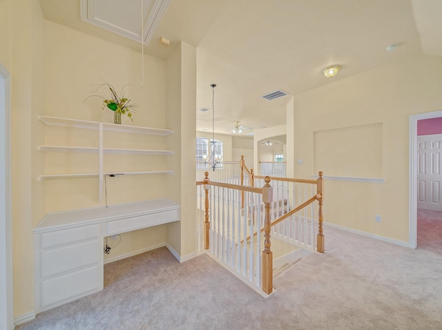 corridor featuring attic access, an upstairs landing, carpet, and visible vents