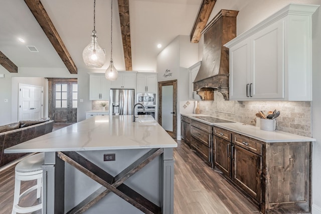 kitchen featuring visible vents, premium range hood, stainless steel appliances, beamed ceiling, and tasteful backsplash