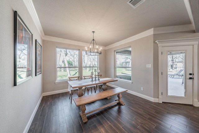 dining area featuring dark wood-type flooring, visible vents, and a wealth of natural light