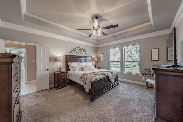 bedroom with light carpet, crown molding, and a raised ceiling