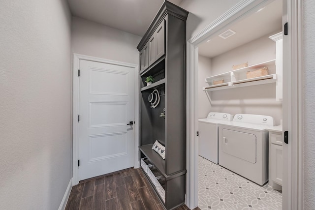 washroom featuring laundry area, wood finish floors, visible vents, and washer and clothes dryer