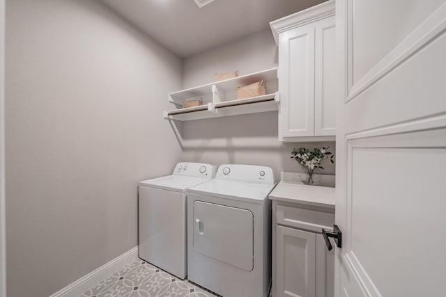 laundry room with baseboards, cabinet space, and washing machine and dryer