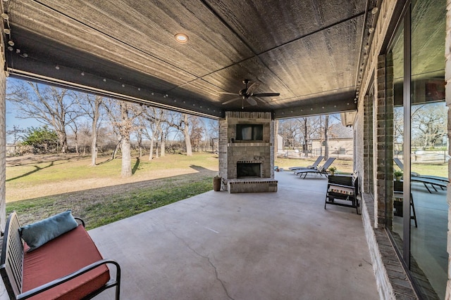 view of patio / terrace with an outdoor brick fireplace and ceiling fan