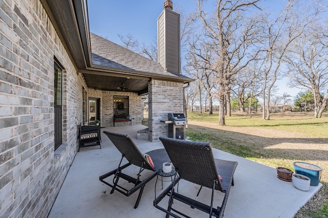 view of patio with area for grilling and a ceiling fan