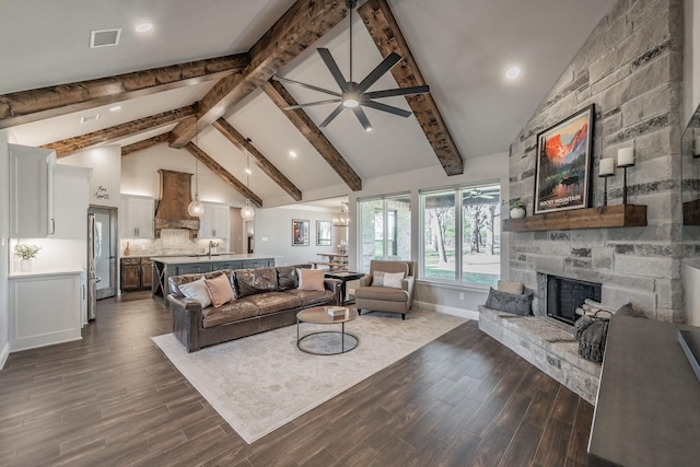 living room with ceiling fan, visible vents, dark wood-style flooring, and a fireplace