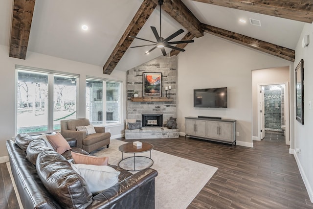 living area featuring dark wood finished floors, beam ceiling, a fireplace, and baseboards