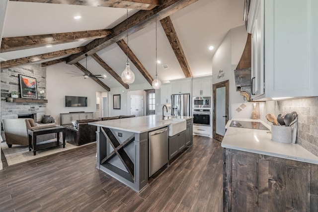 kitchen featuring a sink, tasteful backsplash, stainless steel appliances, light countertops, and dark wood-style flooring