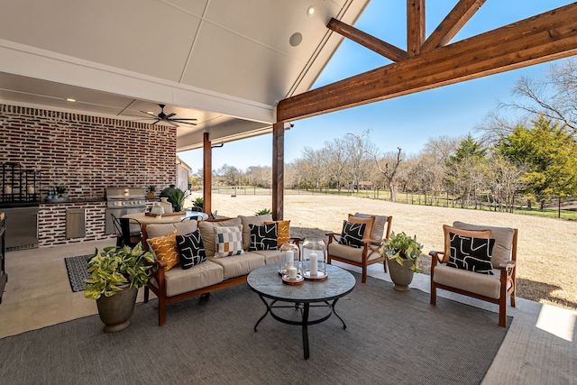 view of patio with area for grilling, outdoor lounge area, a ceiling fan, and fence