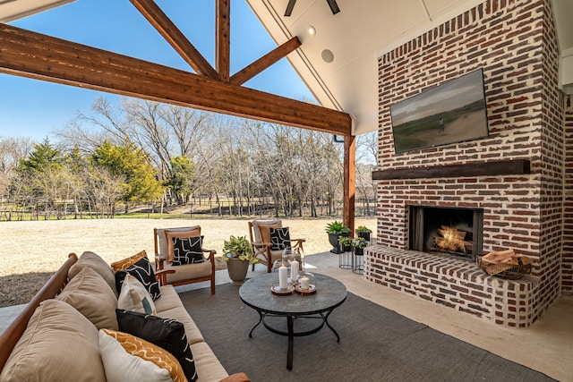 view of patio / terrace with an outdoor living space with a fireplace and fence