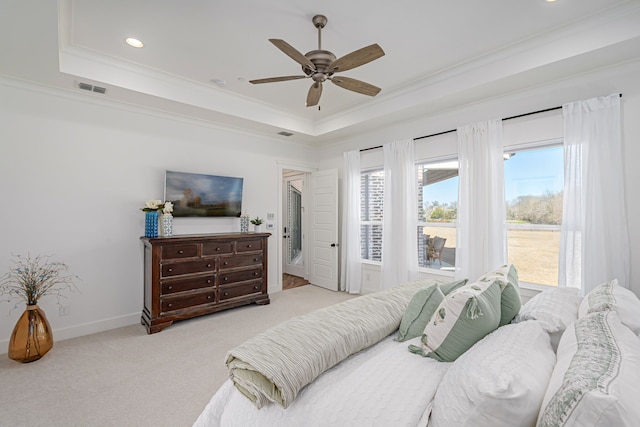 bedroom featuring a raised ceiling, multiple windows, crown molding, and visible vents