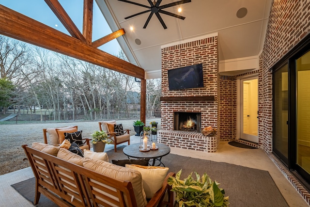 view of patio with fence, ceiling fan, and an outdoor living space with a fireplace