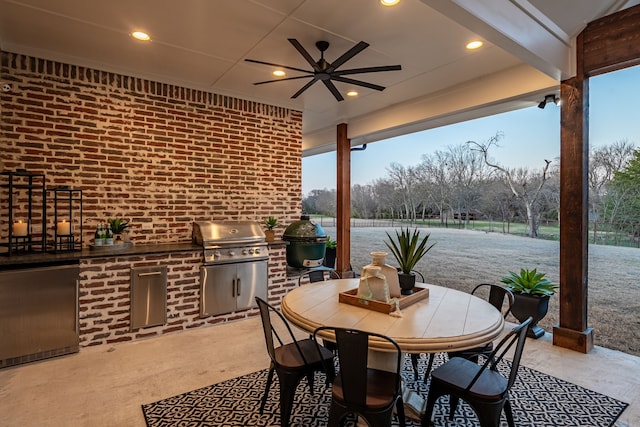 view of patio / terrace with outdoor dining area, area for grilling, exterior kitchen, and a ceiling fan