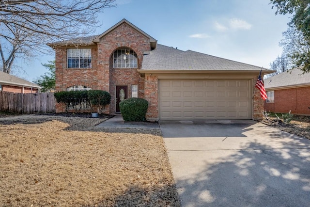 traditional home featuring concrete driveway, a garage, fence, and brick siding