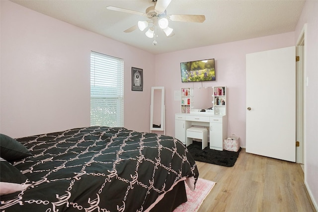 bedroom featuring light wood-style flooring and a ceiling fan