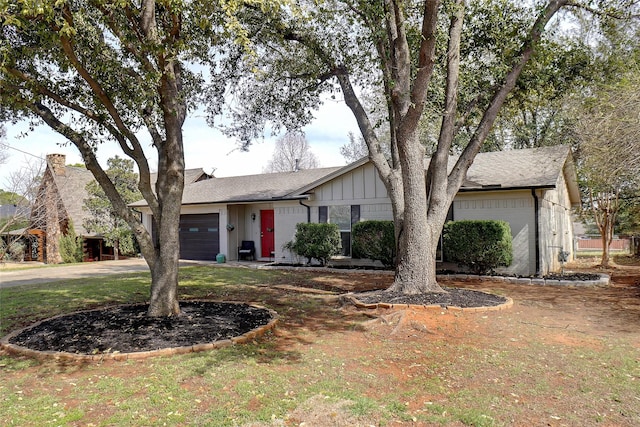 ranch-style house featuring board and batten siding, a garage, and driveway