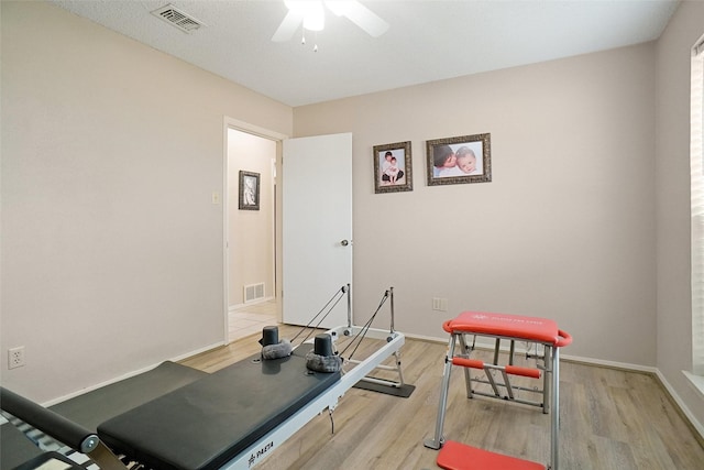 workout area with light wood-style flooring and visible vents