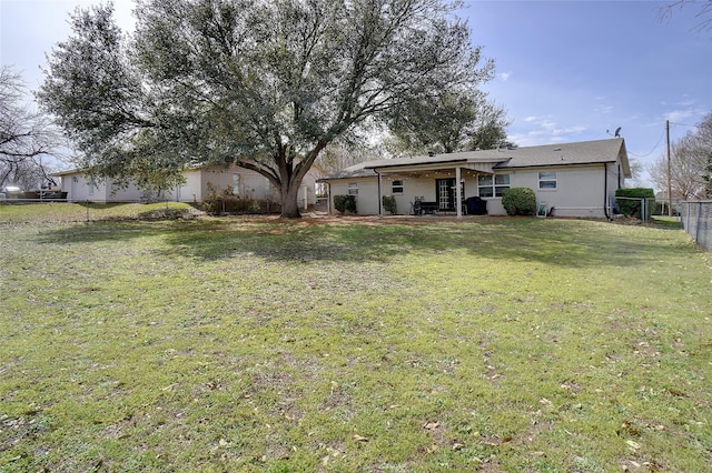 back of property featuring a yard and a fenced backyard