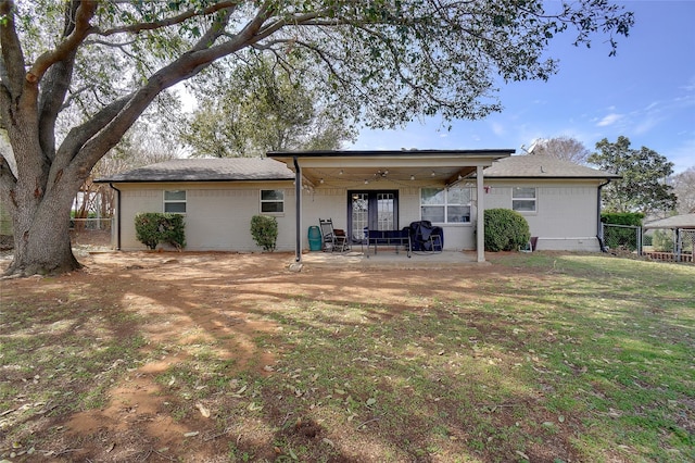 back of house featuring a yard, a ceiling fan, a patio, and fence