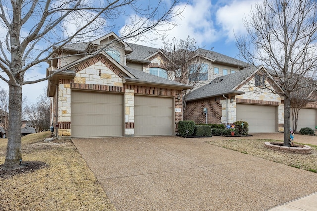 view of front of property featuring concrete driveway, an attached garage, stone siding, and a shingled roof