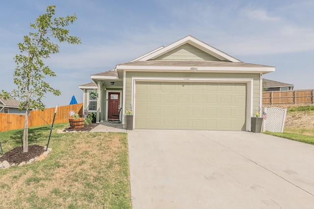 single story home featuring a front yard, an attached garage, fence, and driveway