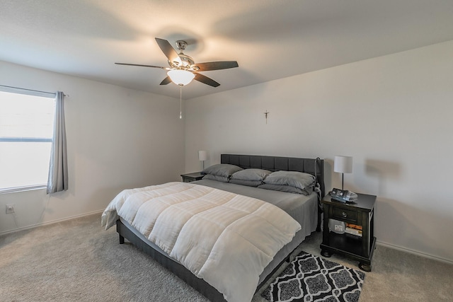 carpeted bedroom with ceiling fan and baseboards