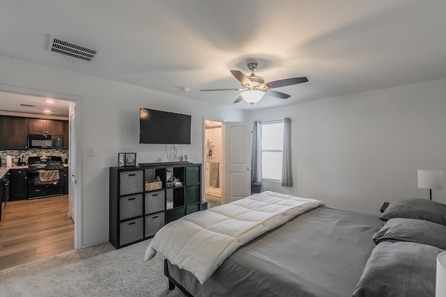 bedroom with light carpet, visible vents, and ceiling fan