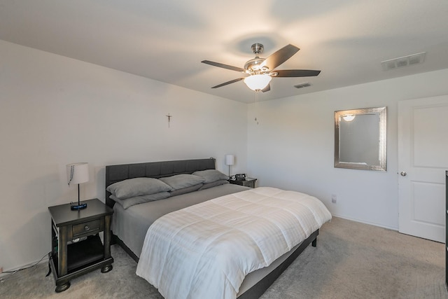 bedroom featuring ceiling fan, visible vents, and light carpet